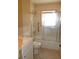 Neutral bathroom with shower and tub with glass door at 5221 Se 107Th Pl, Belleview, FL 34420
