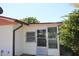 Sunroom exterior with a glass door entry and adjacent awning windows at 5221 Se 107Th Pl, Belleview, FL 34420