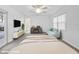 Virtually staged bedroom featuring neutral carpeting, ceiling fan, and an ensuite bathroom for convenience and comfort at 5953 Sailboat Ave, Tavares, FL 32778