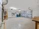 Large garage with epoxy floors, lots of storage, utility sink, and garage door at 5953 Sailboat Ave, Tavares, FL 32778