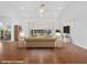 Staged living room features vaulted ceilings, a ceiling fan, and sliding glass doors leading to the lanai at 5953 Sailboat Ave, Tavares, FL 32778