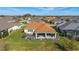 Aerial view of screened-in lanai with outdoor seating and view of the verdant lawn and community at 6126 Mulligan Run, The Villages, FL 32163