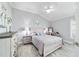 Comfortable bedroom featuring wood-look tile, a ceiling fan, and calming decor at 6126 Mulligan Run, The Villages, FL 32163