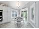 Breakfast nook features white cabinetry, a round table with a black-and-white tablecloth, and bright windows at 6126 Mulligan Run, The Villages, FL 32163