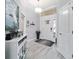 Bright foyer featuring wood-look tile flooring and a charming console table at 6126 Mulligan Run, The Villages, FL 32163