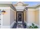 Charming front entrance with decorative door and lantern, enhanced by rock garden and a unique stone walkway at 6126 Mulligan Run, The Villages, FL 32163