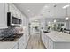 Bright kitchen features marble countertops, stainless steel appliances, a gas range, and light wood flooring at 6126 Mulligan Run, The Villages, FL 32163