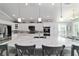 Bright and airy kitchen featuring an island with marble countertops, stainless steel appliances, and white cabinetry at 6126 Mulligan Run, The Villages, FL 32163