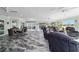 Bright living room featuring beautiful tile flooring, ceiling fans and large windows with a backyard view at 6126 Mulligan Run, The Villages, FL 32163