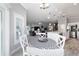 View from the breakfast nook into the open living space, which includes the kitchen and living room at 6126 Mulligan Run, The Villages, FL 32163