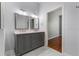 Modern bathroom features a double vanity, white marble floor tiles, and stylish gray cabinets and hardware at 6200 Topsail Rd, Lady Lake, FL 32159