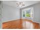 Spacious bedroom featuring hardwood floors, ceiling fan, and bay windows at 6200 Topsail Rd, Lady Lake, FL 32159