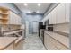 Bright kitchen with beige countertops, ample cabinet space, and modern black appliances and fixtures at 6200 Topsail Rd, Lady Lake, FL 32159