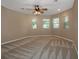 Bright bedroom with multiple windows and neutral carpet at 7549 Frog Log Ln, Leesburg, FL 34748