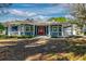 Beautiful blue home with a wraparound porch and well-maintained landscaping at 7549 Frog Log Ln, Leesburg, FL 34748