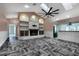 Living room featuring a fireplace, custom built-ins, and herringbone flooring at 7549 Frog Log Ln, Leesburg, FL 34748