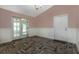 A living room with wainscotting and french doors leading to a screened in porch at 7549 Frog Log Ln, Leesburg, FL 34748