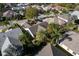 Aerial view capturing a residential community with lush greenery and well-kept properties, highlighting neighborhood appeal at 891 Lucky Ln, The Villages, FL 32162