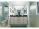 This bathroom features double sinks, a shower with glass door, and tiled floors at 891 Lucky Ln, The Villages, FL 32162