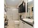 Bathroom featuring a shower-tub combo with a framed sliding glass door and a dark granite vanity at 891 Lucky Ln, The Villages, FL 32162