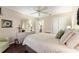 Bedroom featuring a bed, dresser, ceiling fan, and a window with natural light at 891 Lucky Ln, The Villages, FL 32162