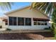 View of the rear exterior featuring a patio and awning providing shade and style at 891 Lucky Ln, The Villages, FL 32162