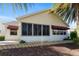 Rear exterior showcasing the patio, awning, and low-maintenance landscaping at 891 Lucky Ln, The Villages, FL 32162