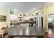 Bright kitchen featuring stainless steel appliances, a breakfast bar, and light green walls at 891 Lucky Ln, The Villages, FL 32162