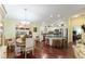 Bright kitchen and dining area with stainless steel appliances and hardwood floors at 891 Lucky Ln, The Villages, FL 32162