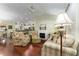 Cozy living room featuring a fireplace and an open layout to the kitchen and dining area at 891 Lucky Ln, The Villages, FL 32162