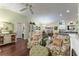 Living room with open floor plan to dining and kitchen with a large china cabinet at 891 Lucky Ln, The Villages, FL 32162