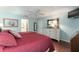 This main bedroom features hardwood floors, a ceiling fan, and light blue walls at 891 Lucky Ln, The Villages, FL 32162