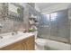 Cozy bathroom with gray tile, a vanity with sink, and a glass-enclosed shower, offering a functional and appealing space at 910 Rich Dr, Mount Dora, FL 32757