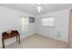 Bedroom with tile floors, a ceiling fan, and two windows, providing ample natural light and a comfortable atmosphere at 910 Rich Dr, Mount Dora, FL 32757