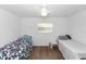 Clean bedroom with two twin beds, wood floors, a ceiling fan, and a window bringing in natural light, ideal for relaxation at 910 Rich Dr, Mount Dora, FL 32757