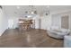 An open-concept living room features hardwood flooring and a view of the kitchen island at 910 Rich Dr, Mount Dora, FL 32757