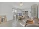 Open-concept living room featuring tile floors, a large window, a sofa, and a dining table at 910 Rich Dr, Mount Dora, FL 32757