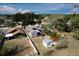 Aerial view of the property showcasing a fenced yard with shed and mature trees at 948 Dora Ave, Tavares, FL 32778