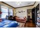 Bedroom featuring hardwood floors, study desk, couch, with doorway and bookshelves at 948 Dora Ave, Tavares, FL 32778