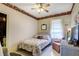 Bright bedroom featuring a bed, arm chair, white floors and neutral colored walls at 948 Dora Ave, Tavares, FL 32778