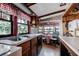 Charming kitchen featuring a window-side dining nook, stainless steel sink and bright natural light at 948 Dora Ave, Tavares, FL 32778