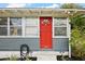 Close-up of the bright red front door, complemented by stylish exterior details at 952 W Montrose St, Clermont, FL 34711