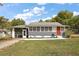 Charming single-story home with a well-manicured lawn and a striking red front door at 952 W Montrose St, Clermont, FL 34711