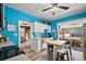 Bright kitchen featuring blue walls, white cabinets, and a functional island with seating at 952 W Montrose St, Clermont, FL 34711