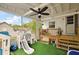 Covered patio featuring a play area with a slide and seating, perfect for outdoor enjoyment at 952 W Montrose St, Clermont, FL 34711