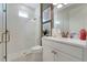 The bathroom features a glass-enclosed shower, modern fixtures, and a white vanity with gold hardware at 981 Fiesta Key Cir, Lady Lake, FL 32159