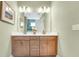 Spacious bathroom featuring a double sink vanity with modern fixtures and a glass shower enclosure at 981 Fiesta Key Cir, Lady Lake, FL 32159