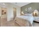 Stylish bedroom showcases an en suite closet, complemented by elegant decor and wood look tile flooring at 981 Fiesta Key Cir, Lady Lake, FL 32159
