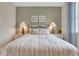 This bedroom showcases a neatly made bed with decorative pillows and matching bedside tables and lamps at 981 Fiesta Key Cir, Lady Lake, FL 32159