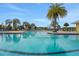 Spacious community pool area with ample seating and lush landscaping at 981 Fiesta Key Cir, Lady Lake, FL 32159